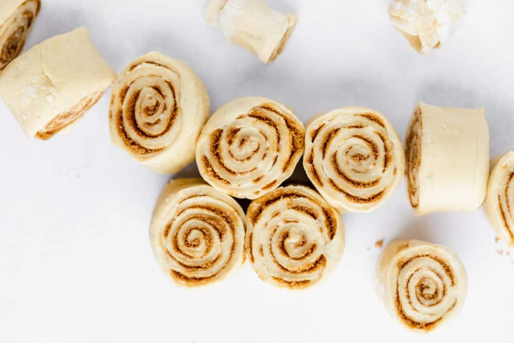 raw cinnamon roll dough rolled up and cut into 1.25 inch rolls before the second proofing