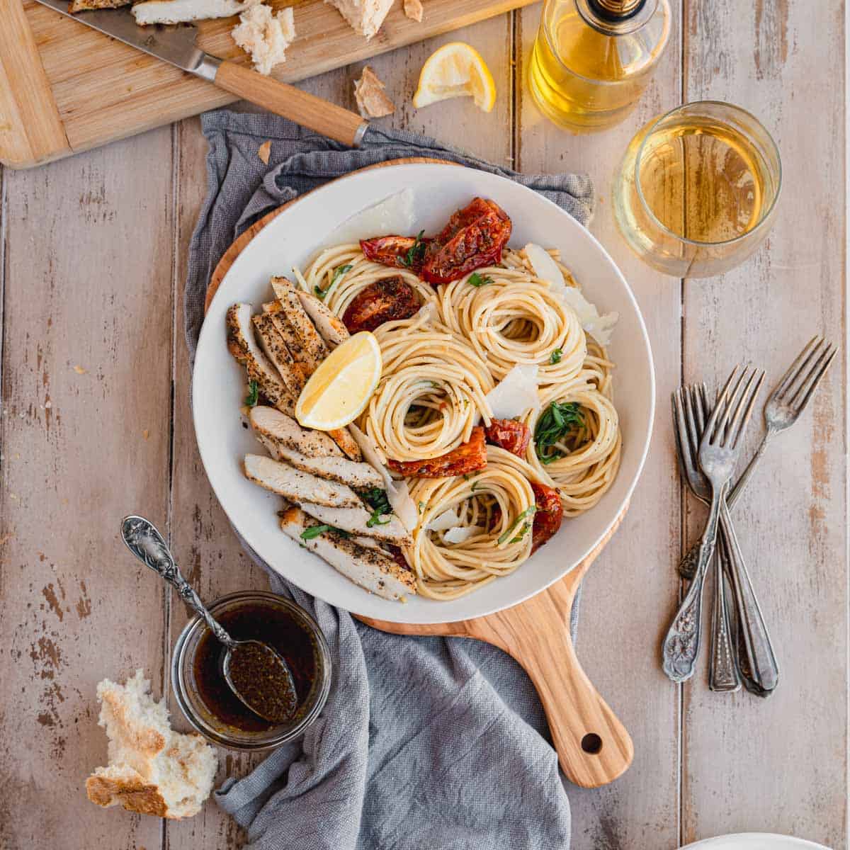 Garlic Parmesan Chicken Pasta in a bowl on a small cheese board.