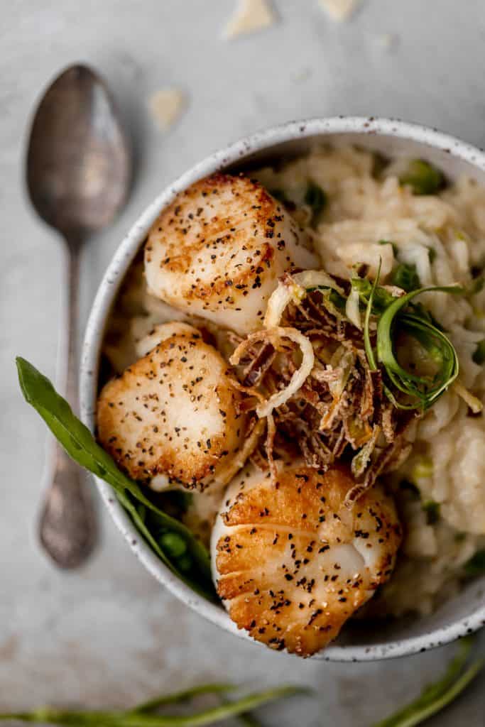 a bowl of risotto with scallops