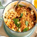 Mac and Cheese with herbed bread crumbs in a pot with fresh parsley on top.