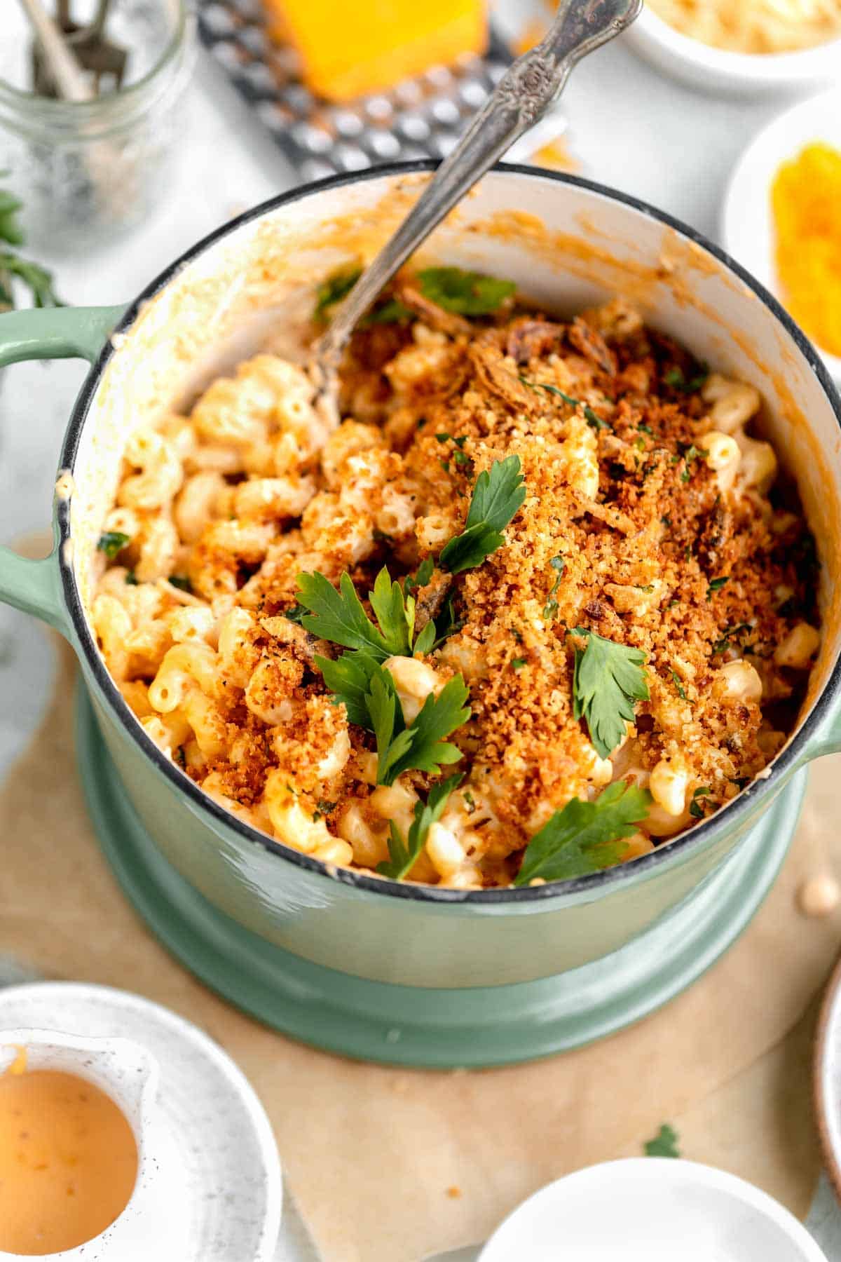 Mac and Cheese with herbed bread crumbs in a pot with fresh parsley on top. 