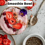 Strawberry banana smoothie bowl with a plate of freeze dried strawberries and chia seeds