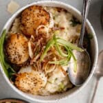 Seared Scallops and Risotto in a bowl with fried leeks.