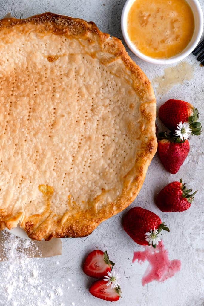 pie crust with strawberries and egg wash