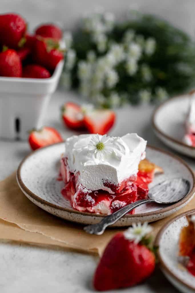 a slice of strawberry pie on a plate thats been cut into