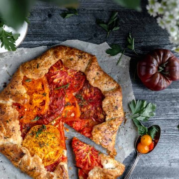 heirloom tomato galette with one slice cut out of it