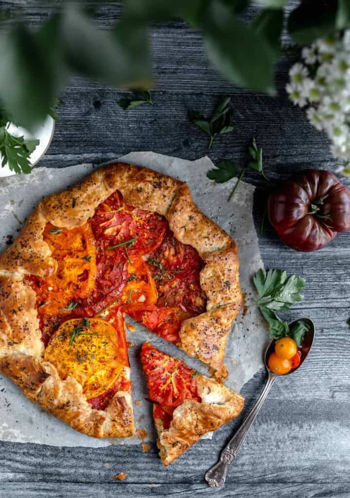 heirloom tomato galette with one slice cut out of it