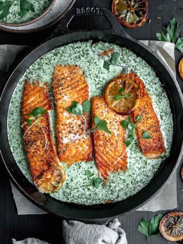 Cast Iron Salmon topped with creamy schug sauce and cilantro.