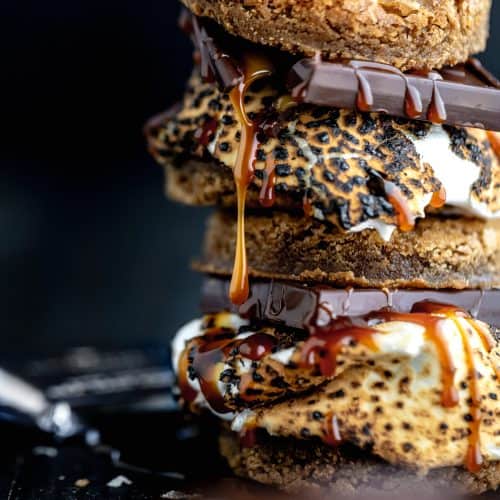 stack of brown butter graham cracker blondie s'mores with caramel dripping down the side