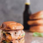 the ultimate pork burger with sauce dripping down the front