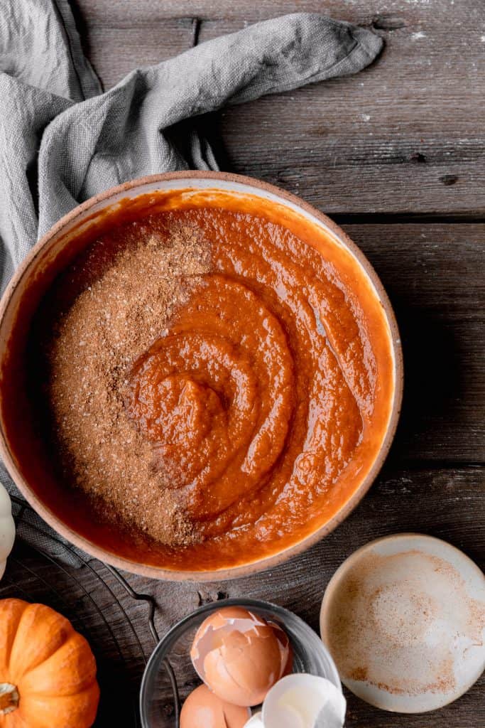 pumpkin pie filling with the pumpkin pie spices dumped on top in a bowl