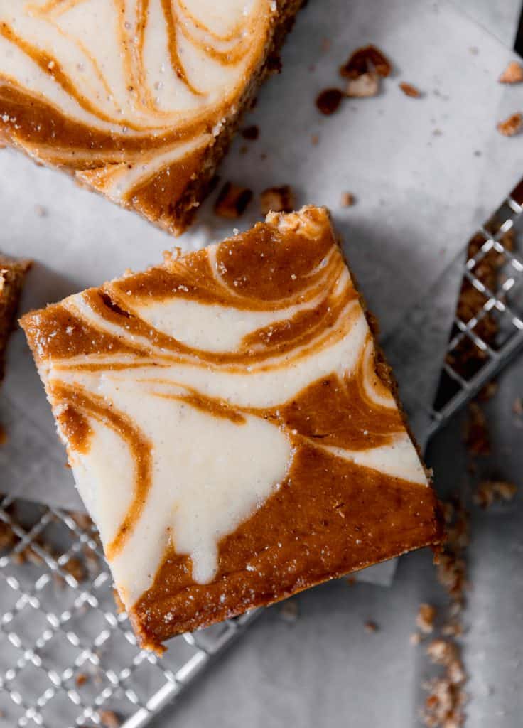top view of a pumpkin cheesecake bar with swirls