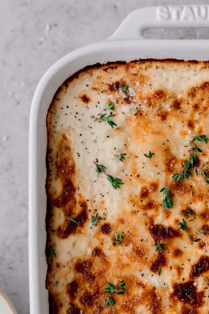 au gratin potatoes baked in a dish until bubbly and golden brown