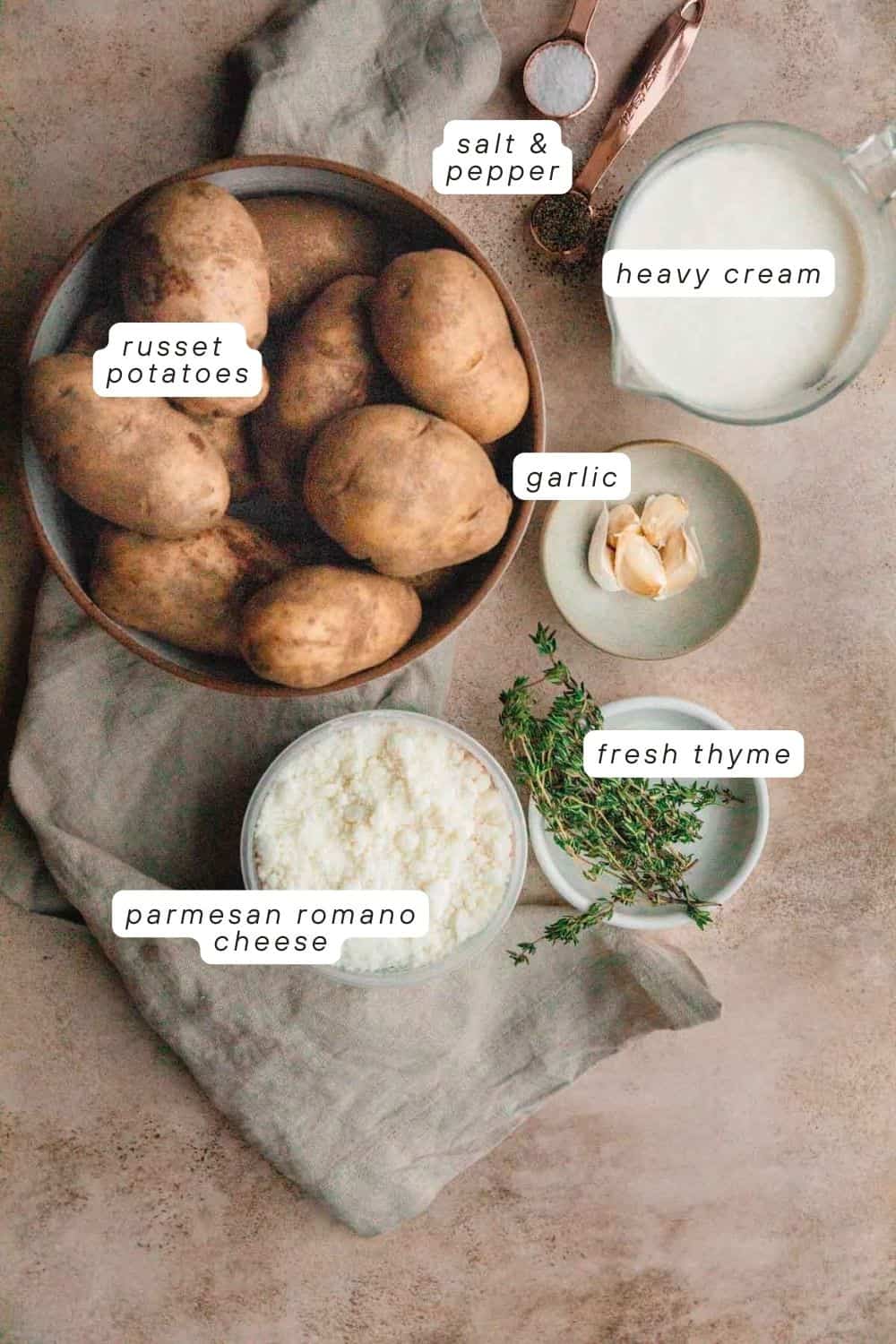 Russet potatoes, salt, pepper, heavy cream, garlic, fresh thyme, parmesan Romano cheese. 