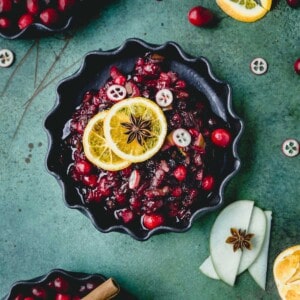 Cranberry Sauce in a dish with oranges and star anise.