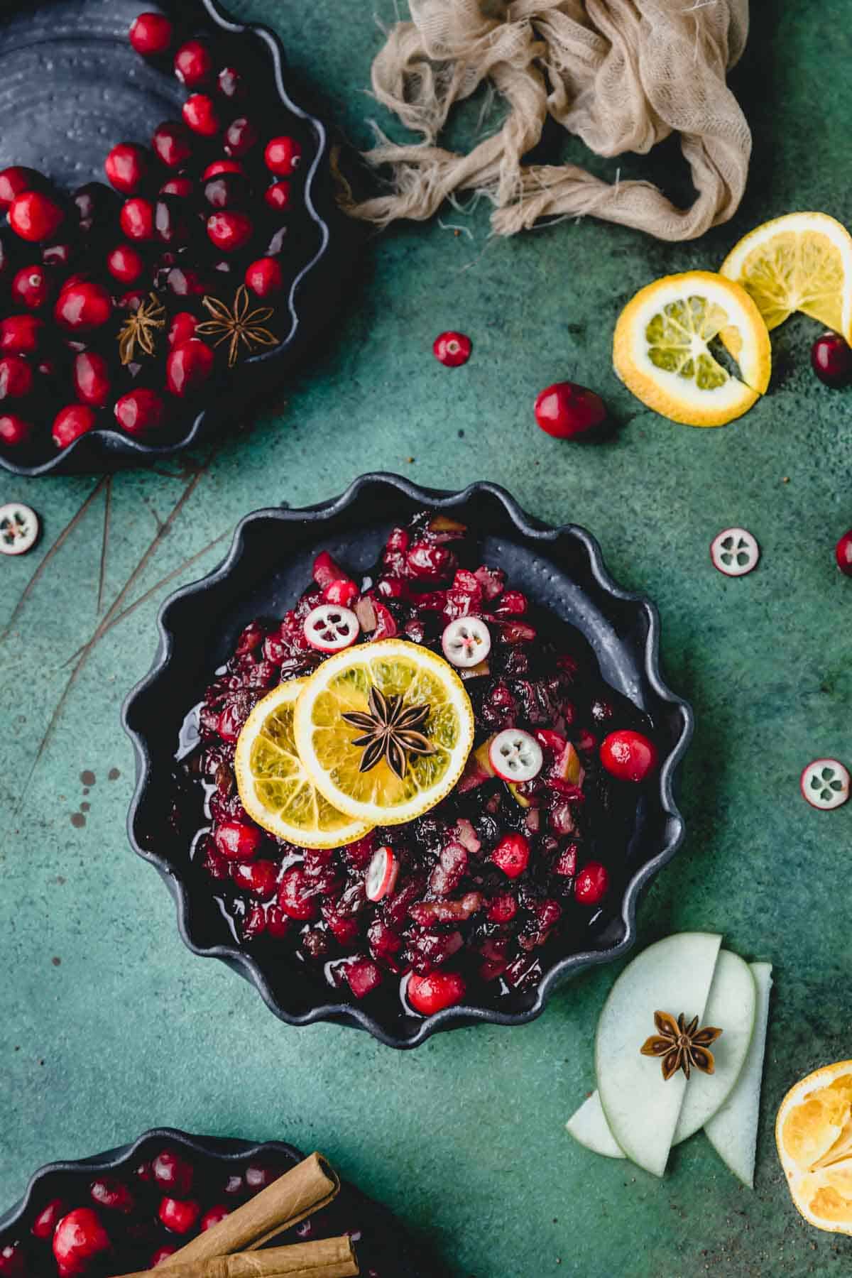 Cranberry Sauce in a dish with oranges and star anise. 