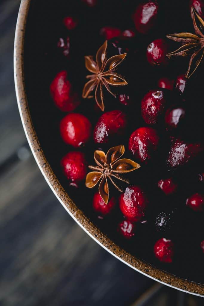 cranberries in a bowl with star anise