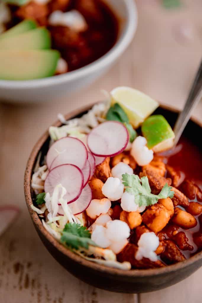 bowl of pozole rojo with all the toppings