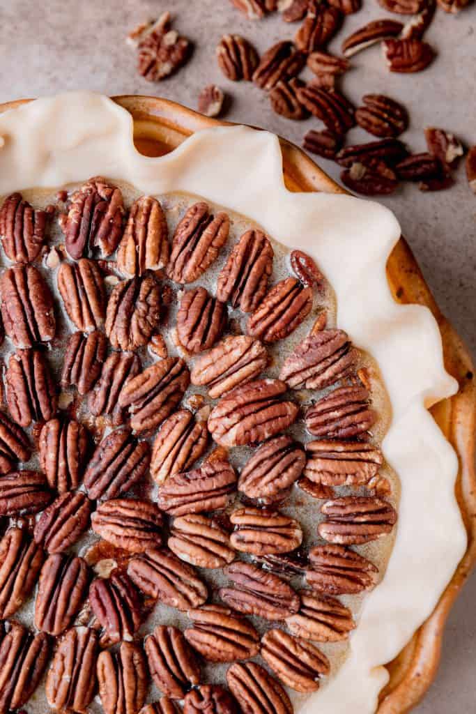 pecan pie with pecans arranged in a decoration on top