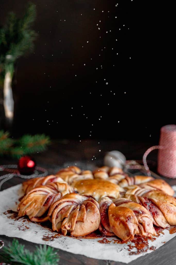 raspberry star bread with Christmas string, ornaments and pine