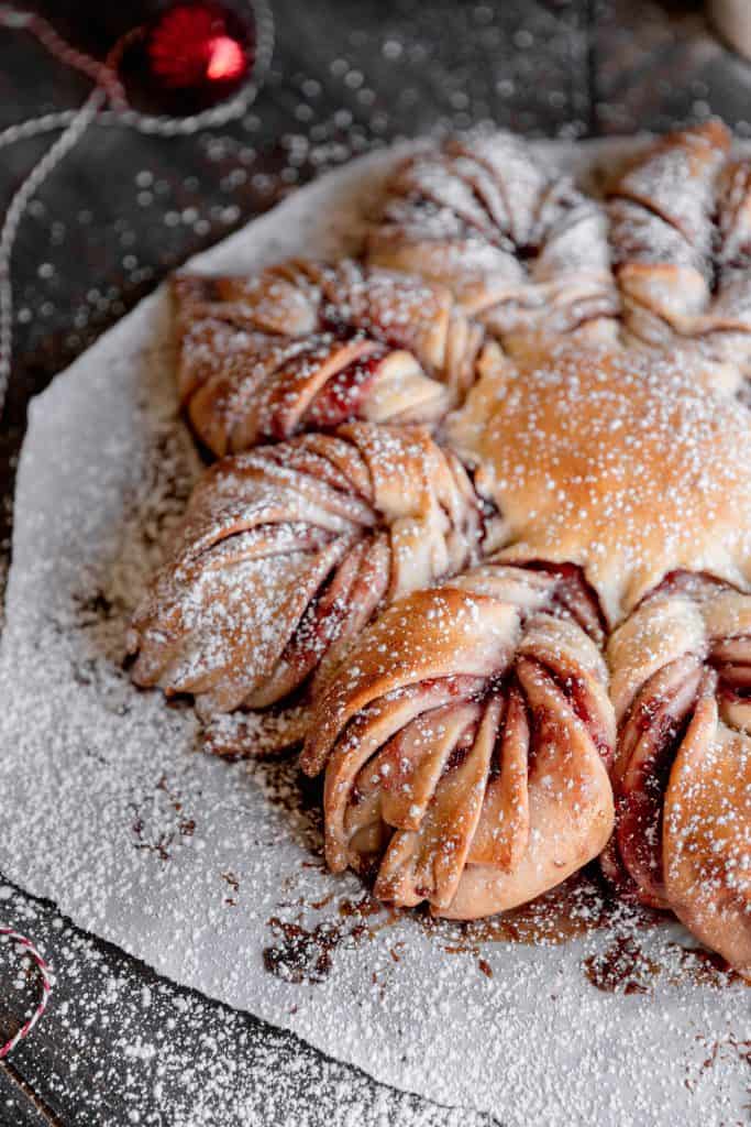 raspberry star bread with powdered sugar dusted on top