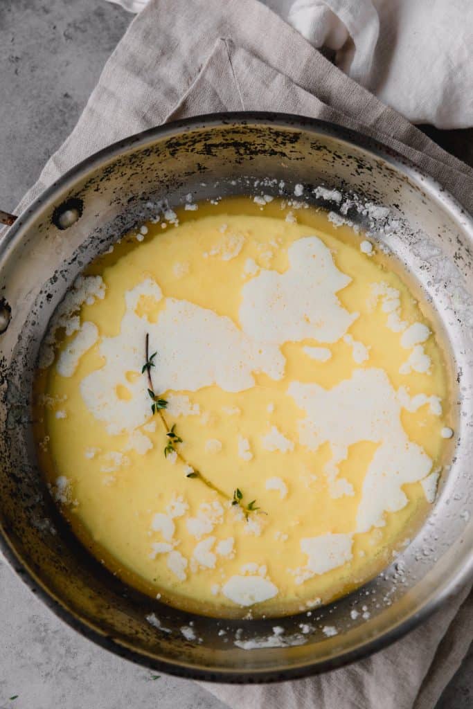 a sauce pan with milk and butter melted