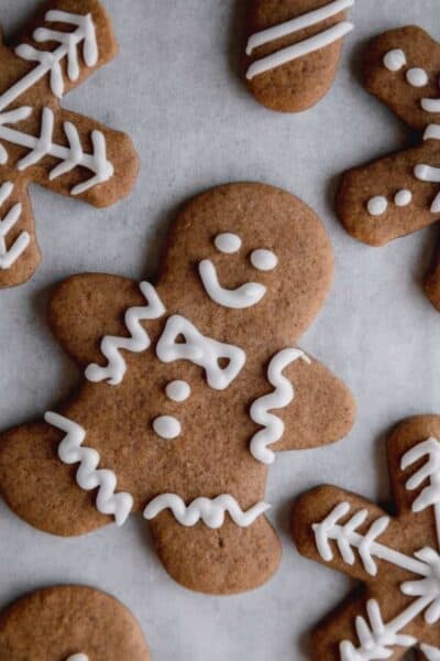 Frosted gingerbread cookies on parchment paper.