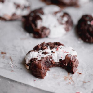 Hot Chocolate Cookies with marshmallow and crushed candy cane on top.