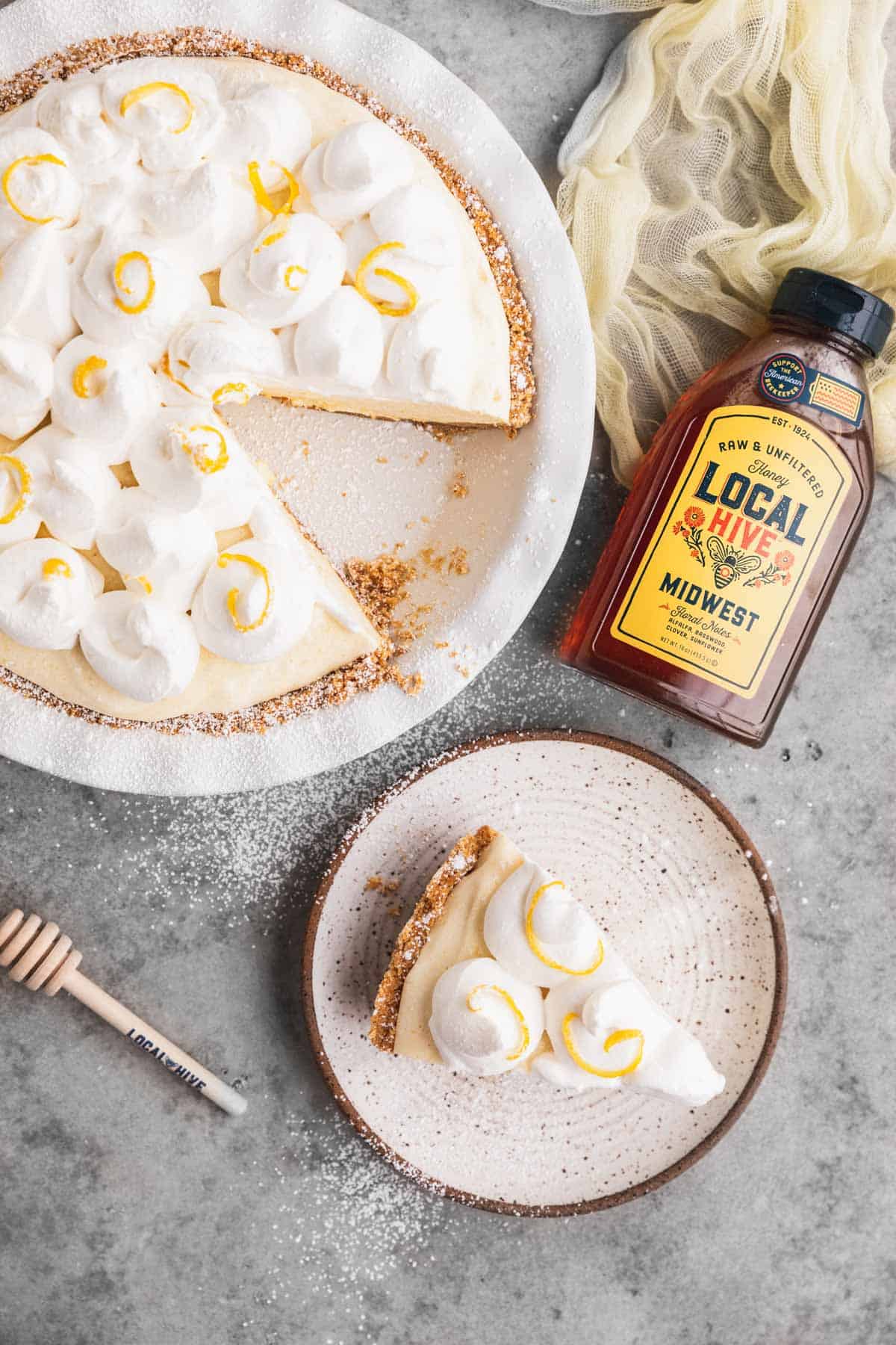 Lemon Chiffon Pie with a slice cut out and set on a plate.