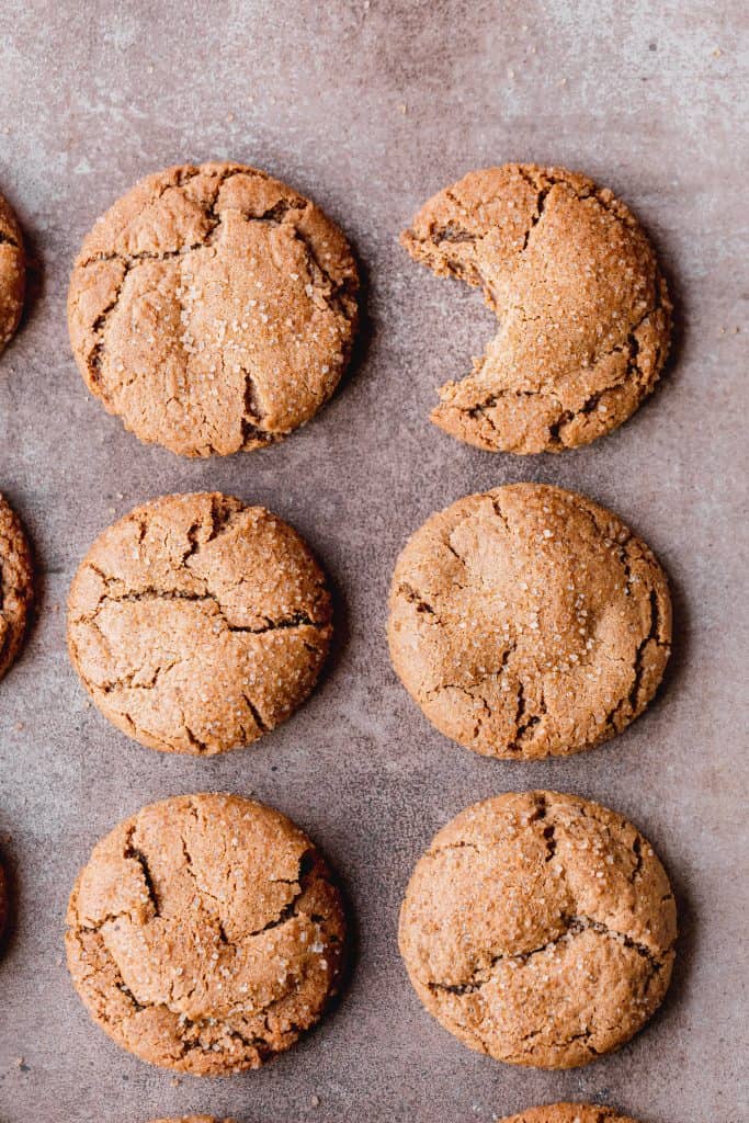 molasses cookies in a row with a bite out of one of them