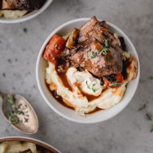 Red Wine Braised Short Ribs over mashed potatoes and gravy in a bowl.