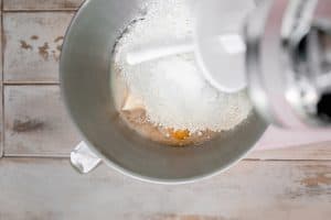 butter, egg and flour being added to the yeast mixture