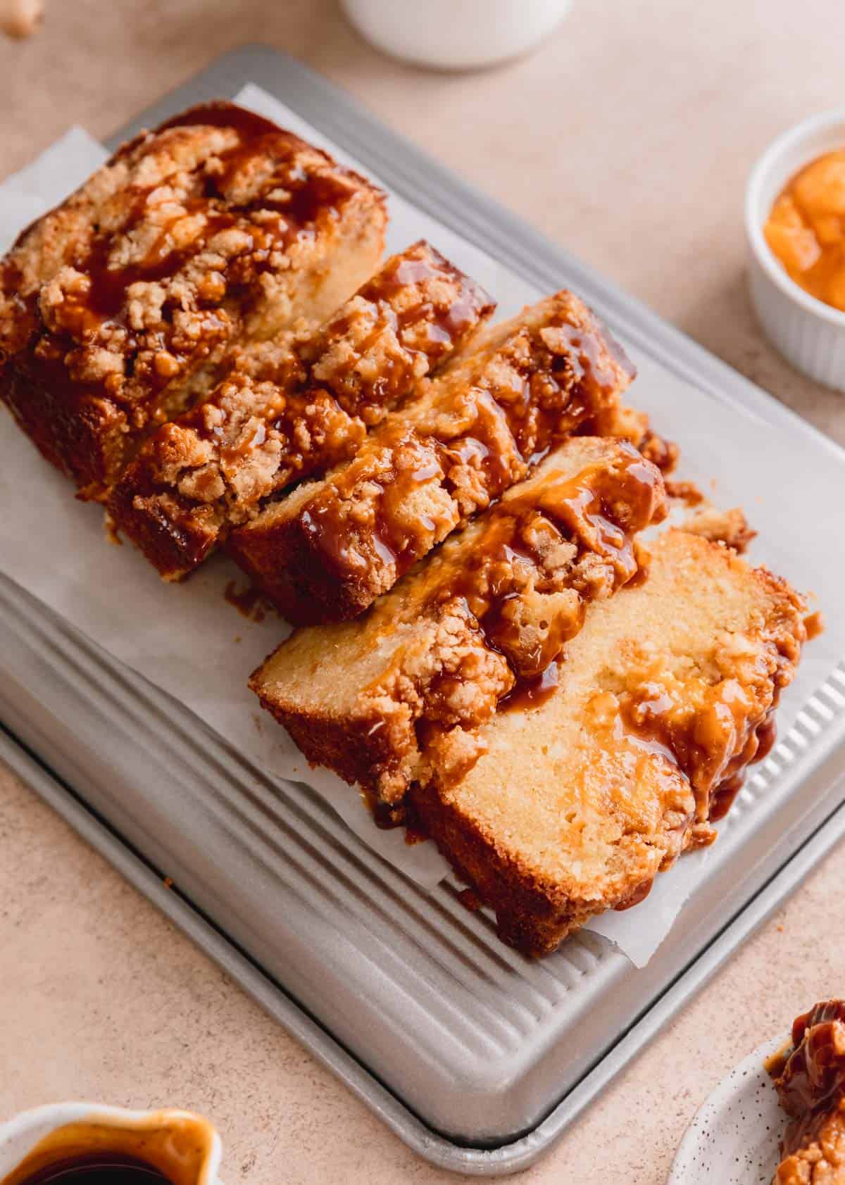 Peach Cobbler Pound Cake cut into slices on top of a baking sheet. 