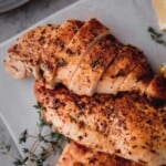 Air Fryer Chicken Breast sliced on a board.