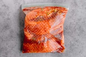 salmon marinating in a plastic bag