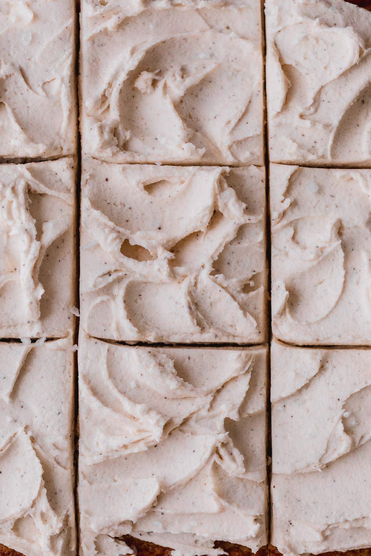 Banana bars with brown butter frosting cut into squares. 