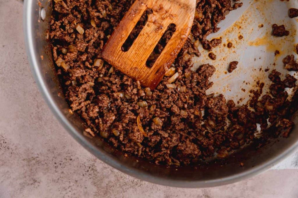 Taco ground beef fully cooked in a large skillet. 