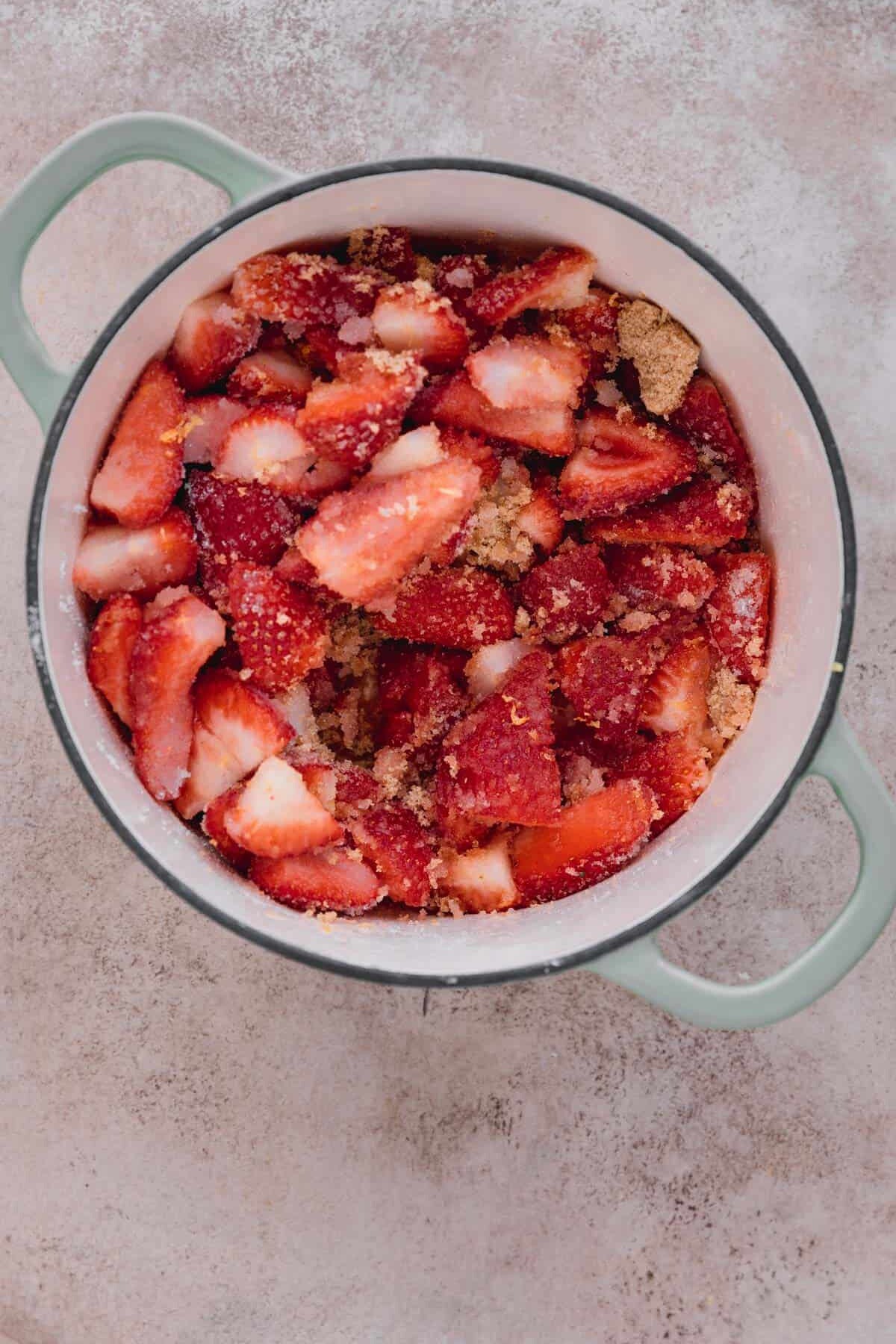 Strawberry jam ingredients in a pot.
