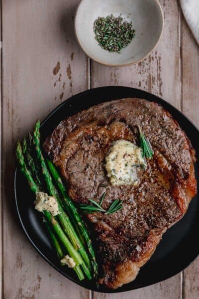 Air fryer ribeye steak with compound butter on top.