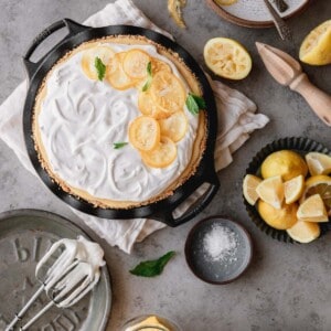 Creamy Lemon Pie topped with candied lemon and whipped cream swirls.
