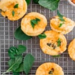 Egg Bites with Boursin Cheese and spinach on a cooling rack.