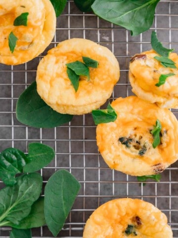 Egg Bites with Boursin Cheese and spinach on a cooling rack.