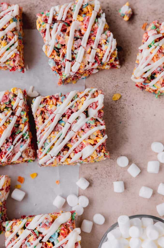 fruity pebbles treats cut into squares with drizzle on top
