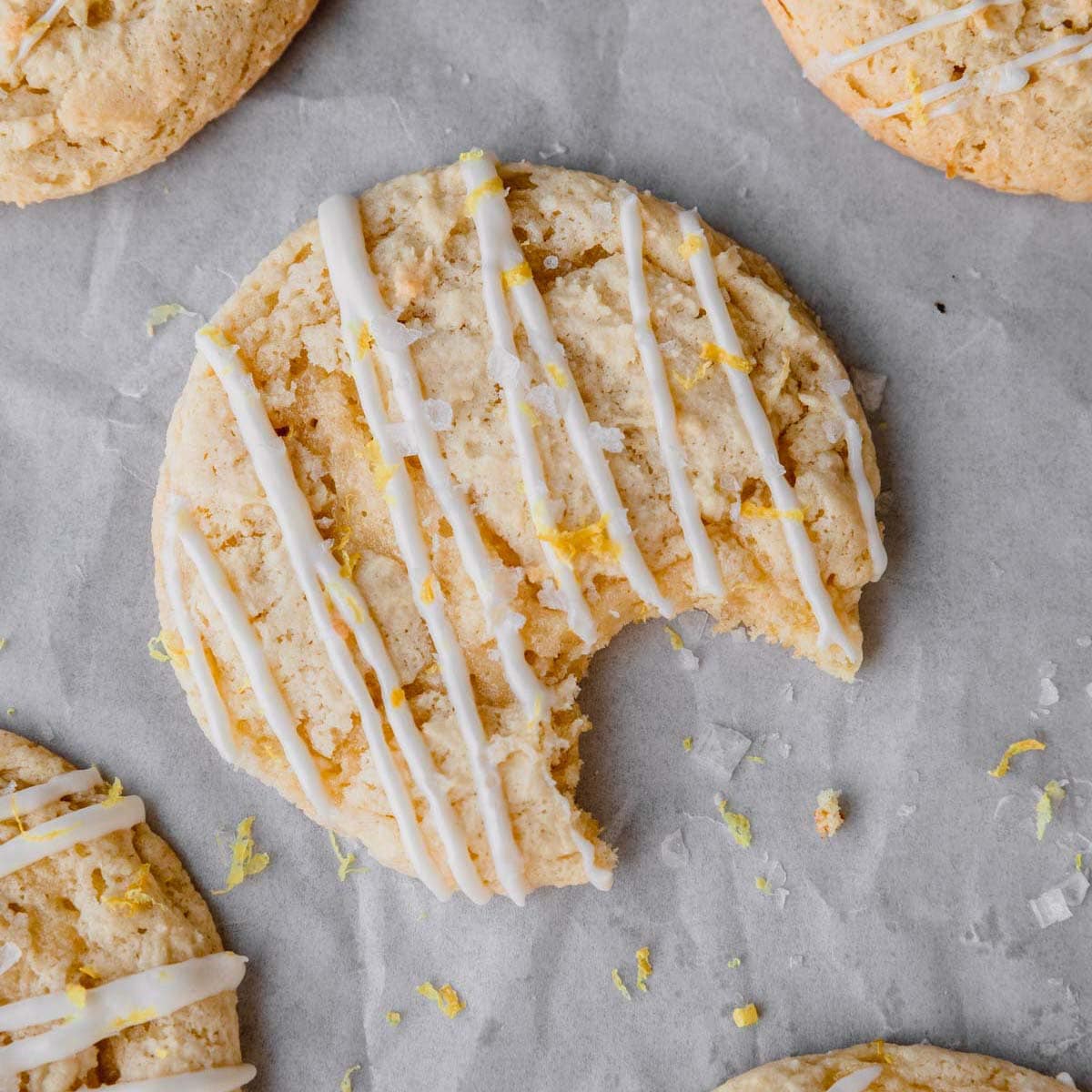 Lemon Ricotta Cookie topped with lemon frosting that has a bite taken out of it.