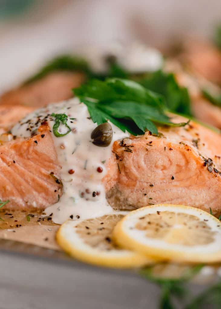 the perfect air fryer salmon recipe with tartar sauce and lemon slices