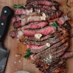 ribeye steak cooked to medium rare, sliced and topped with herbed butter