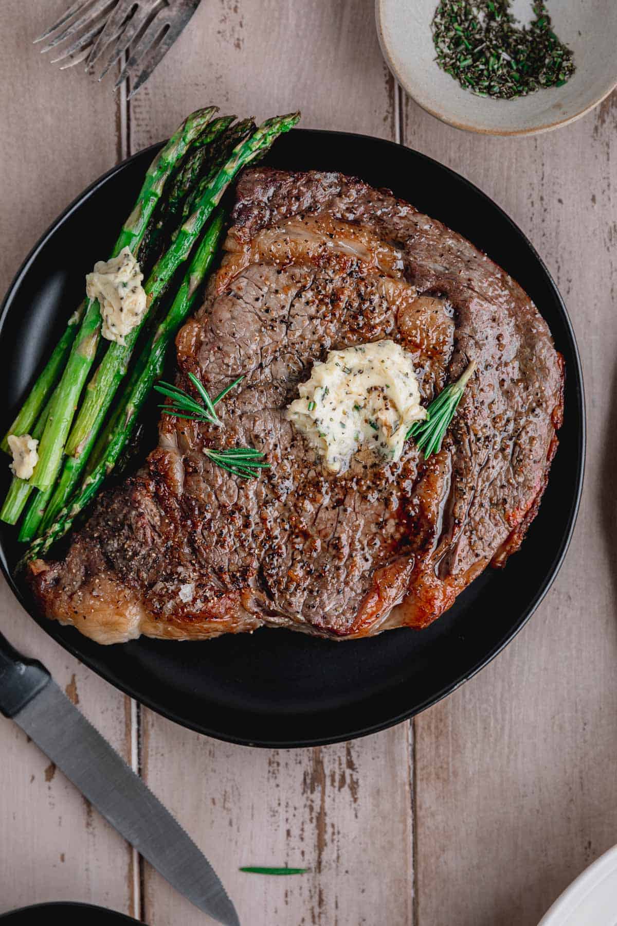 Air Fryer Ribeye Steak with compound butter and asparagus. 