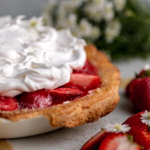 Strawberry Cream Cheese Pie topped with whipped cream.