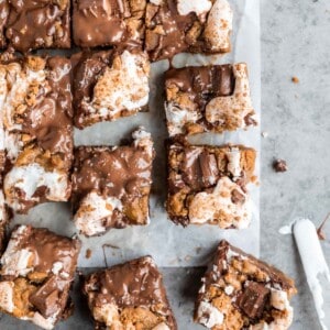 S'mores Cookie Bars cut into squares with gooey marshmallow and melty chocolate on top.