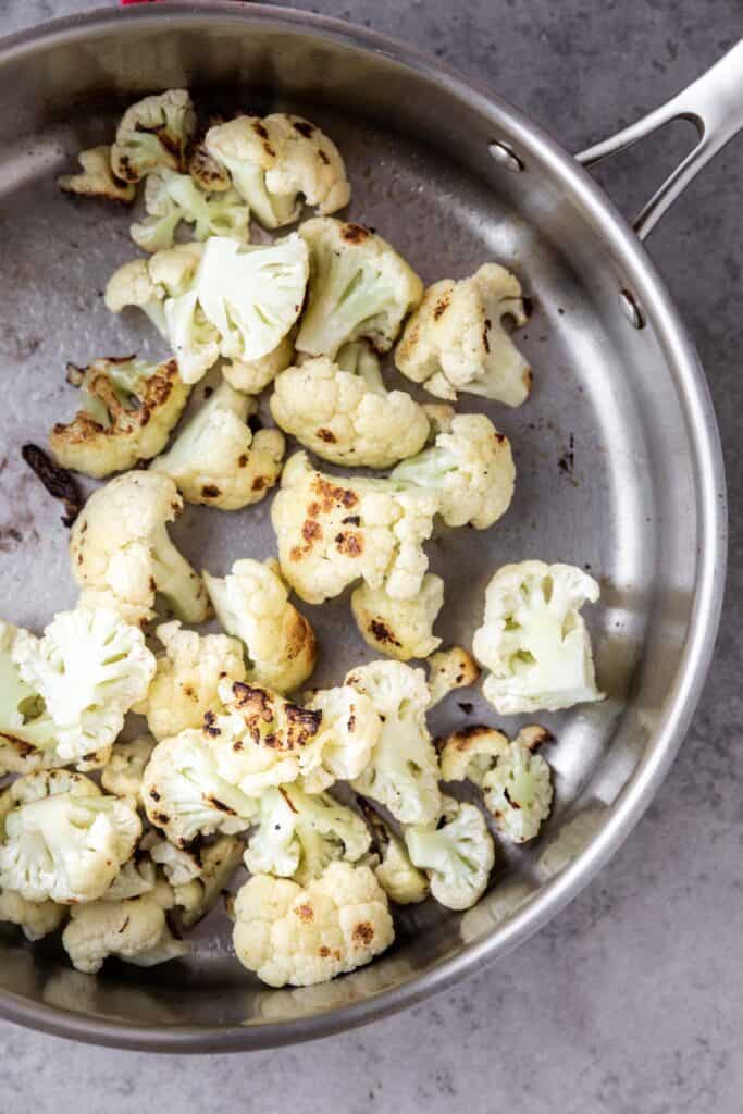 cauliflower cooked in a skillet with brown caramelization